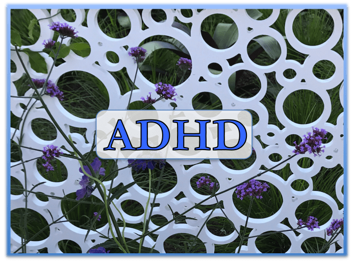 The word ADHD on a patterned wall with purple flowers.