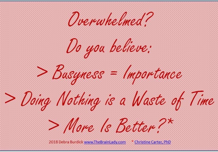 A motivational quote about busyness and doing nothing on a pink background.
