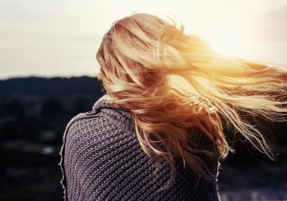 Woman with flowing hair in the sunset.